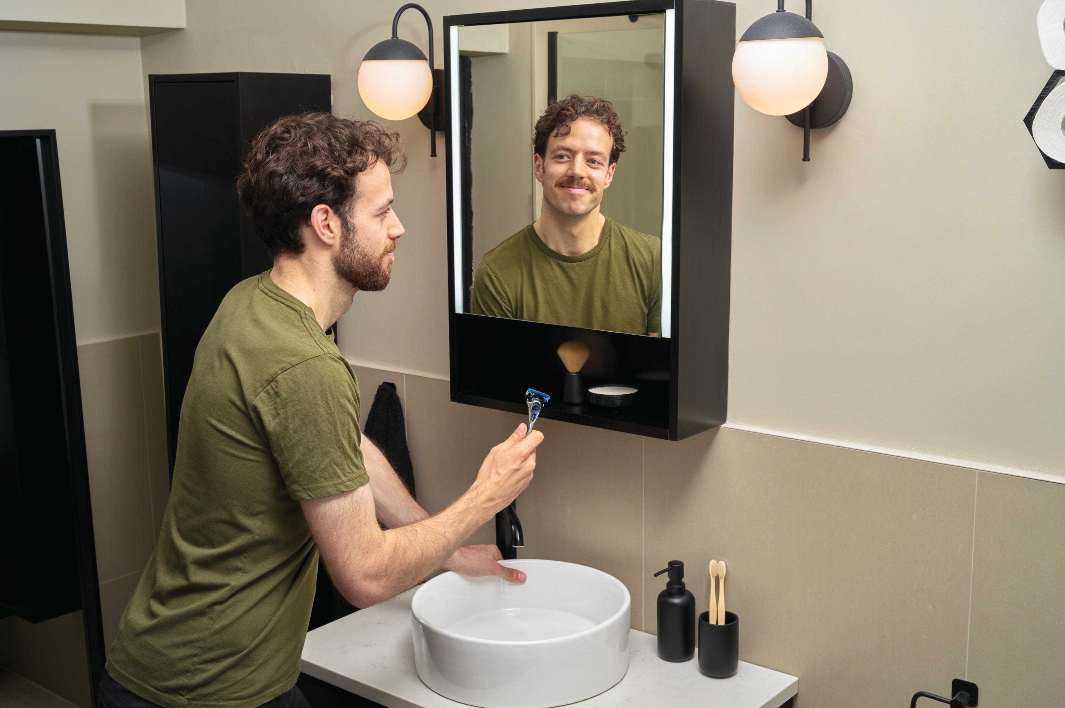Man with moustache using Wilkinson Sword razor