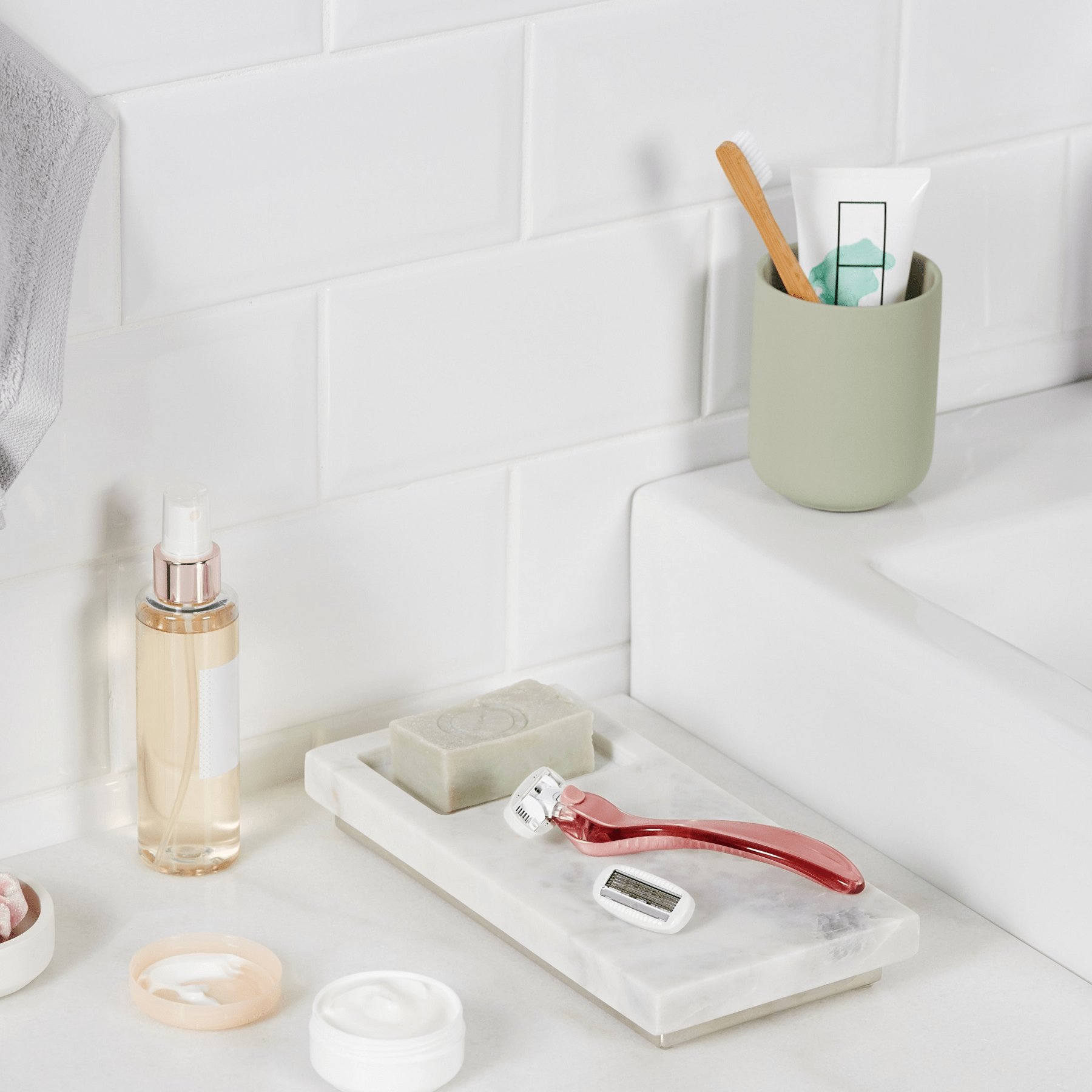 Women's Wilkinson Sword razor on the side of the bath